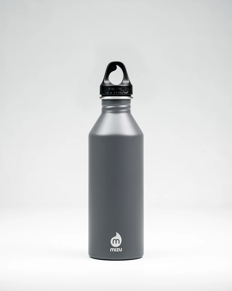 A slate-grey aluminium bottle on a pale surface