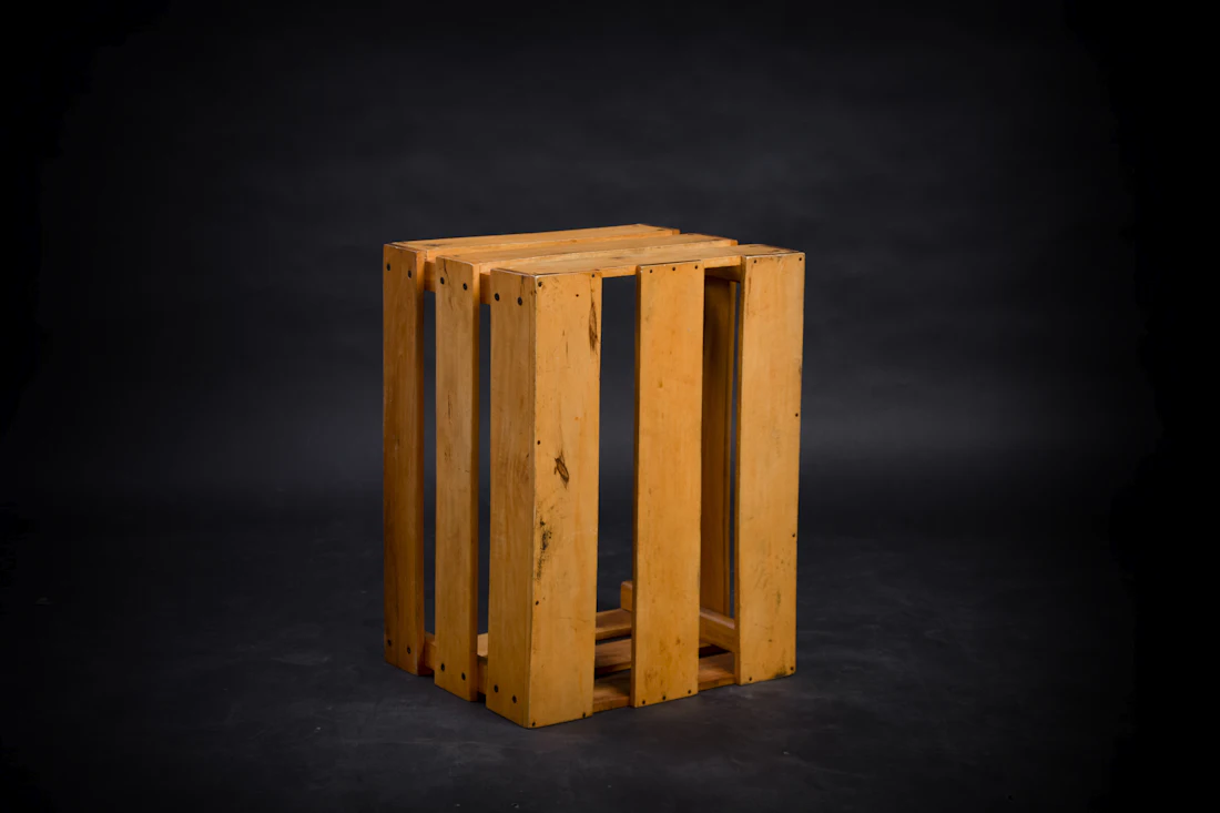 A slatted wooden crate on a black backdrop
